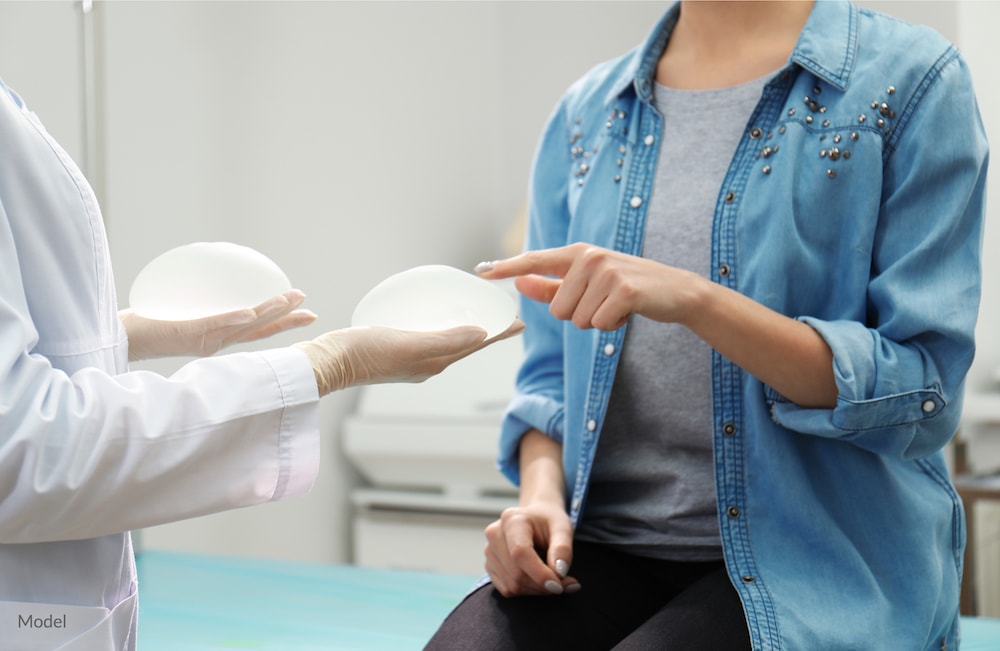 Woman getting breast implant consultation with doctor.